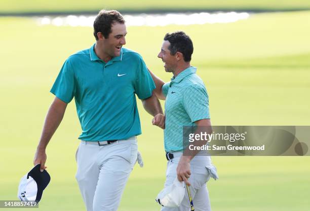 Scottie Scheffler of the United States congratulates Rory McIlroy of Northern Ireland on the 18th green after McIlroy won during the final round of...