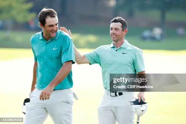 Scottie Scheffler of the United States congratulates Rory McIlroy of Northern Ireland on the 18th green after McIlroy won during the final round of...