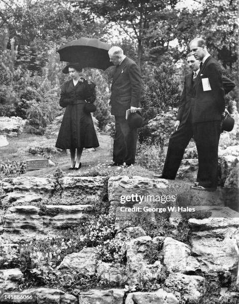 Queen Elizabeth II and Prince Philip admiring the rock garden at the Chelsea Flower Show, London, 20th May 1952. The garden was designed by Winkfield...