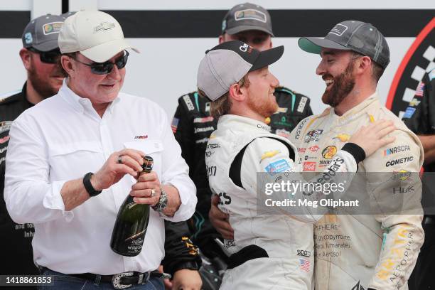 Austin Dillon, driver of the BREZTRI Chevrolet, is congratulated by Tyler Reddick, driver of the Cheddar's Scratch Kitchen Chevrolet, as team owner,...