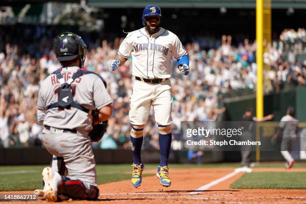 Carlos Santana of the Seattle Mariners celebrates a solo home run by Ty France in the seventh inning against the Cleveland Guardians at T-Mobile Park...