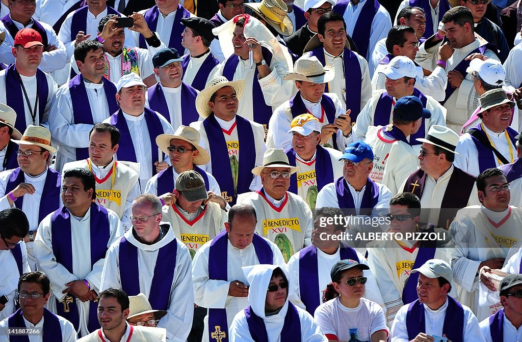 Priests attend an open-air mass celebrat