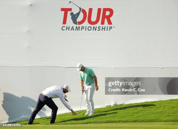 Rory McIlroy of Northern Ireland gets a ruling on the 18th hole during the final round of the TOUR Championship at East Lake Golf Club on August 28,...