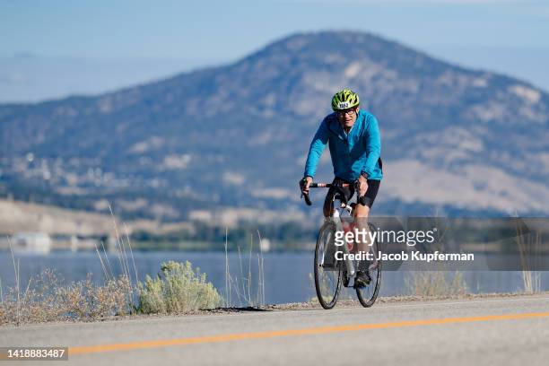 Athletes compete in the bike portion during the IRONMAN Canada on August 28, 2022 in Penticton, British Columbia.