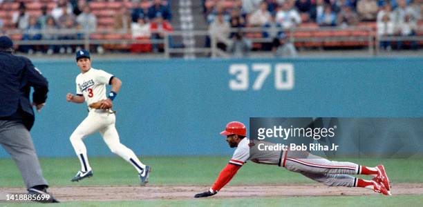 St. Louis Cardinals Ozzie Smith gets the jump on Dodgers Pitcher Fernando Valenzuela, then slides safely into 2nd base during playoff series of the...