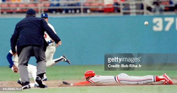 St. Louis Cardinals Ozzie Smith gets the jump on Dodgers Pitcher Fernando Valenzuela, then slides safely into 2nd base during playoff series of the...