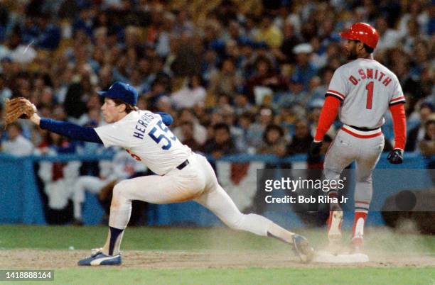 Los Angeles Dodgers Pitcher Orel Hershiser stretches after St. Louis Cardinals Ozzie Smith lays down a bunt during Los Angeles Dodgers vs St. Louis...