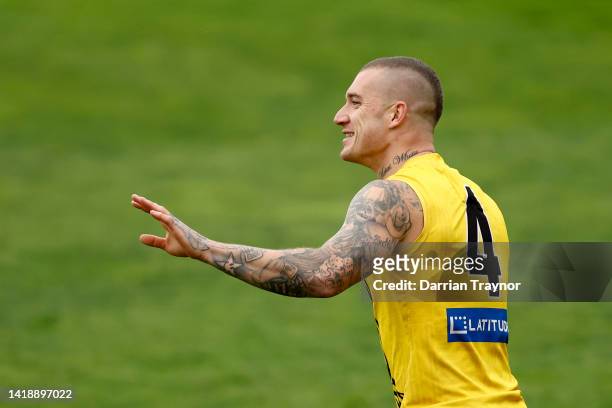 Dustin Martin of the Tigers enjoys a laugh during a Richmond Tigers AFL training session at Punt Road Oval on August 29, 2022 in Melbourne, Australia.