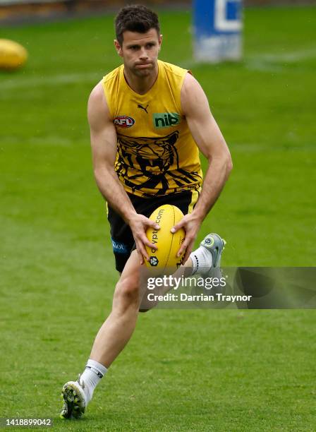 Trent Cotchin of the Tigers runs with the ball during a Richmond Tigers AFL training session at Punt Road Oval on August 29, 2022 in Melbourne,...