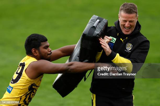 Maurice Rioli of the Tigers tackles Richmond senior coach, Damien Hardwick during a Richmond Tigers AFL training session at Punt Road Oval on August...