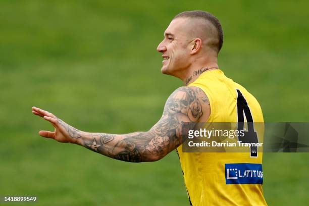 Dustin Martin of the Tigers enjoys a laugh during a Richmond Tigers AFL training session at Punt Road Oval on August 29, 2022 in Melbourne, Australia.