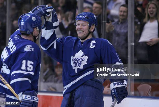 Mats Sundin of the Toronto Maple Leafs celebrates with Tomas Kaberle after scoring a goal in the first period in NHL game action against the Boston...