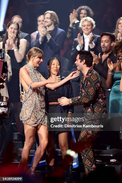 Taylor Swift, Rina Yang, and Dylan O'Brien accept the Video of the Year award onstage at the 2022 MTV VMAs at Prudential Center on August 28, 2022 in...