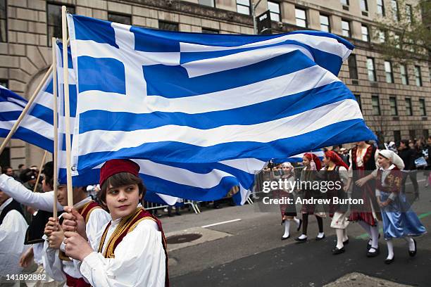 Boy participating in the annual Greek Independence Day Parade carries a Greek flag down Fifth Avenue on March 25, 2012 in New York City. It was the...