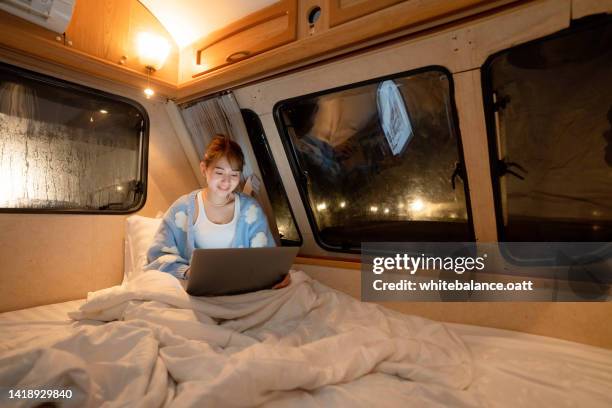 asian female tourist working late at night - duvet inners stock pictures, royalty-free photos & images