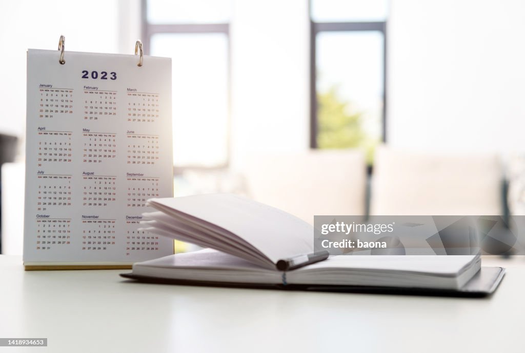 2023 calendar and note pad on the desk
