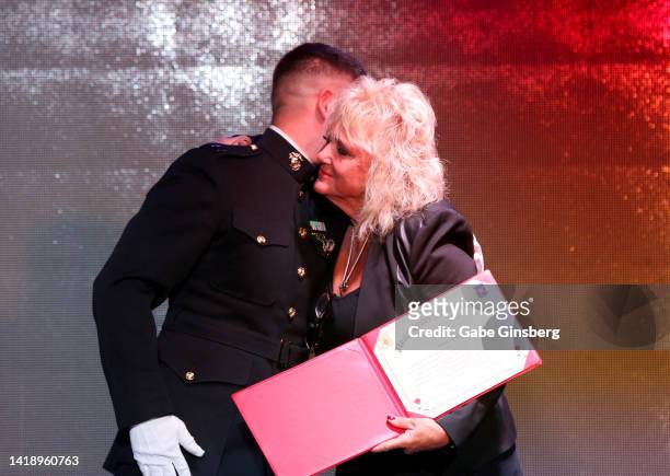 Member of the 23rd U.S. Marine Regiment color guard presents a Certificate of Appreciation to Brenda Glur-Spinks during Leon Spinks celebration of...