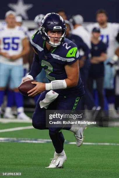 Drew Lock of the Seattle Seahawks scrambles in the pocket against the Dallas Cowboys in an NFL preseason football game at AT&T Stadium on August 26,...