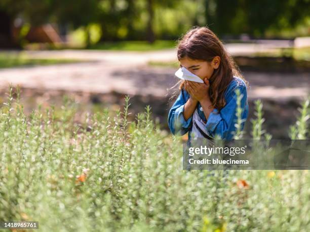 girl with allergy blowing nose - ambrosia stock pictures, royalty-free photos & images