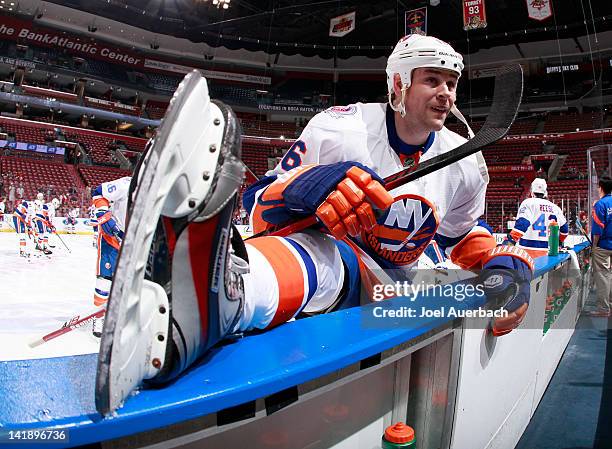 Marty Reasoner of the New York Islanders stretches along the boards prior to the game against the Florida Panthers on March 25, 2012 at the...