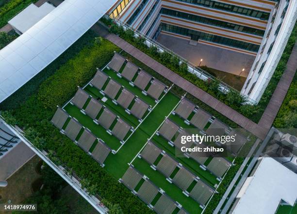 solar water heater overlooking public building roof - district heating plant 個照片及圖片檔