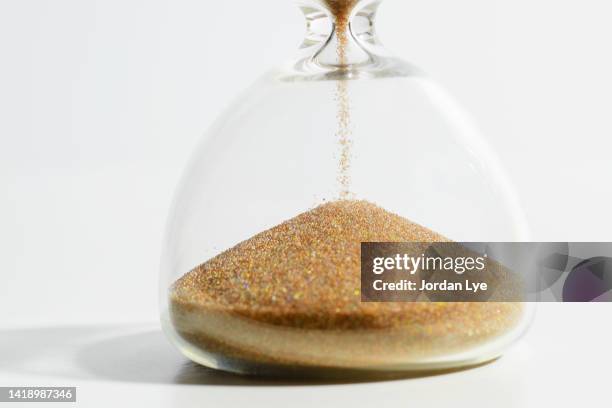 time is gold - hourglass stock pictures, royalty-free photos & images