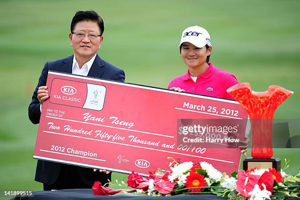 Yani Tseng of Taiwan poses with Byung Mo Ahn, Group President and CEO of Kia Motors America and the cheque after winning the the tournament during...