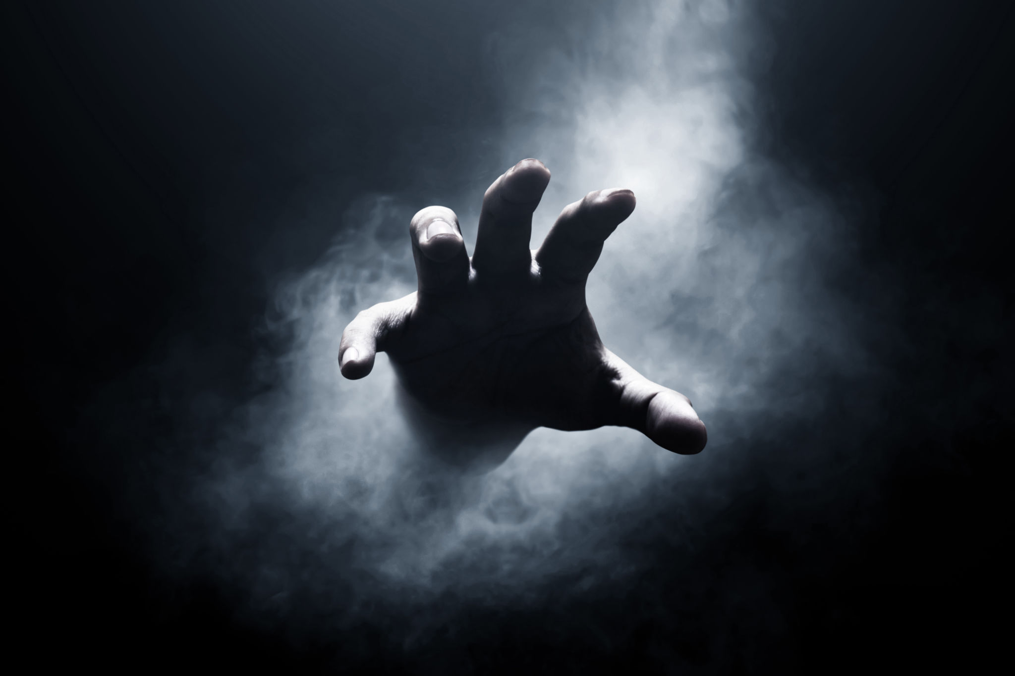 Human hand on dark background Human hand on dark background