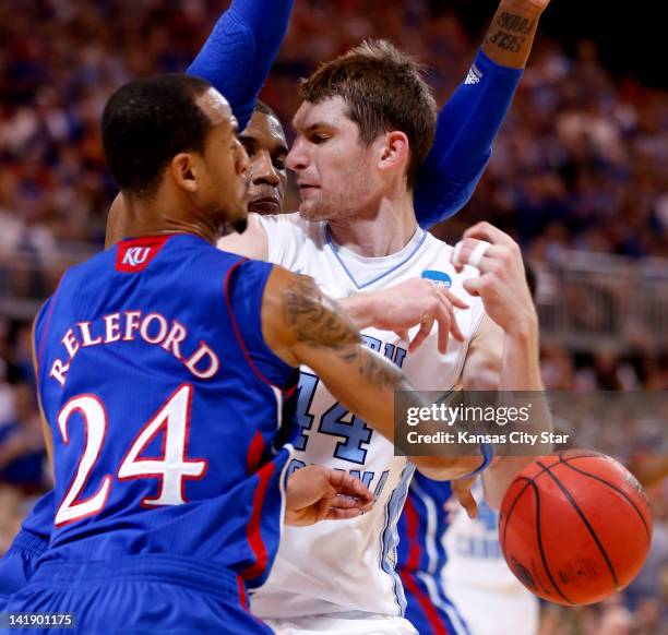 Kansas Jayhawks guard Travis Releford knocked the ball out of the hands of North Carolina Tar Heels forward Tyler Zeller as Kansas Jayhawks forward...