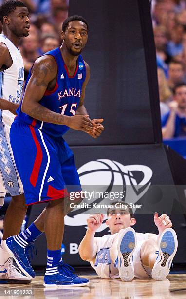 Kansas Jayhawks guard Elijah Johnson reacted after being called on a charge as North Carolina Tar Heels forward Tyler Zeller looked up from the floor...