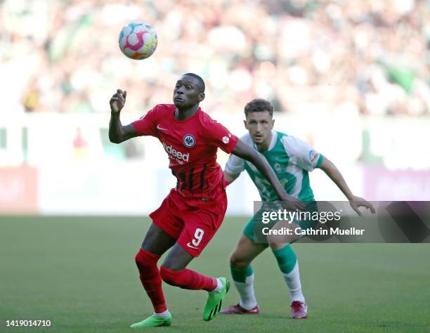 Randal Kolo Muani of Eintracht Frankfurt is challenged by Milos Veljkovic of Werder Bremen during the Bundesliga match between SV Werder Bremen and...