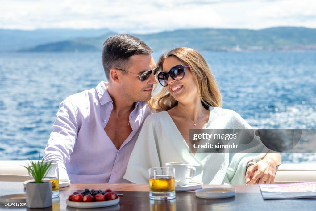 Couple relaxing on yacht
