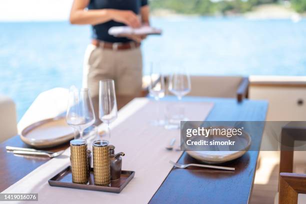 table setting on yacht - luxury yacht stock pictures, royalty-free photos & images