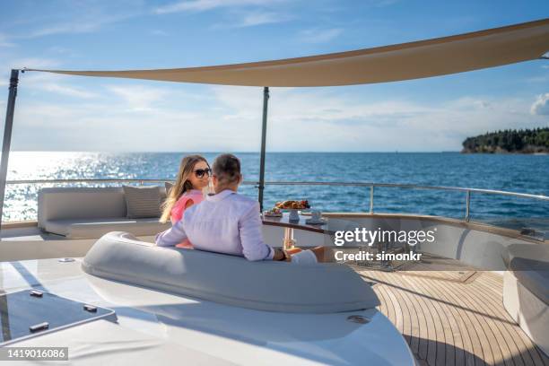 couple relaxing on luxury yacht - luxury yachts stockfoto's en -beelden