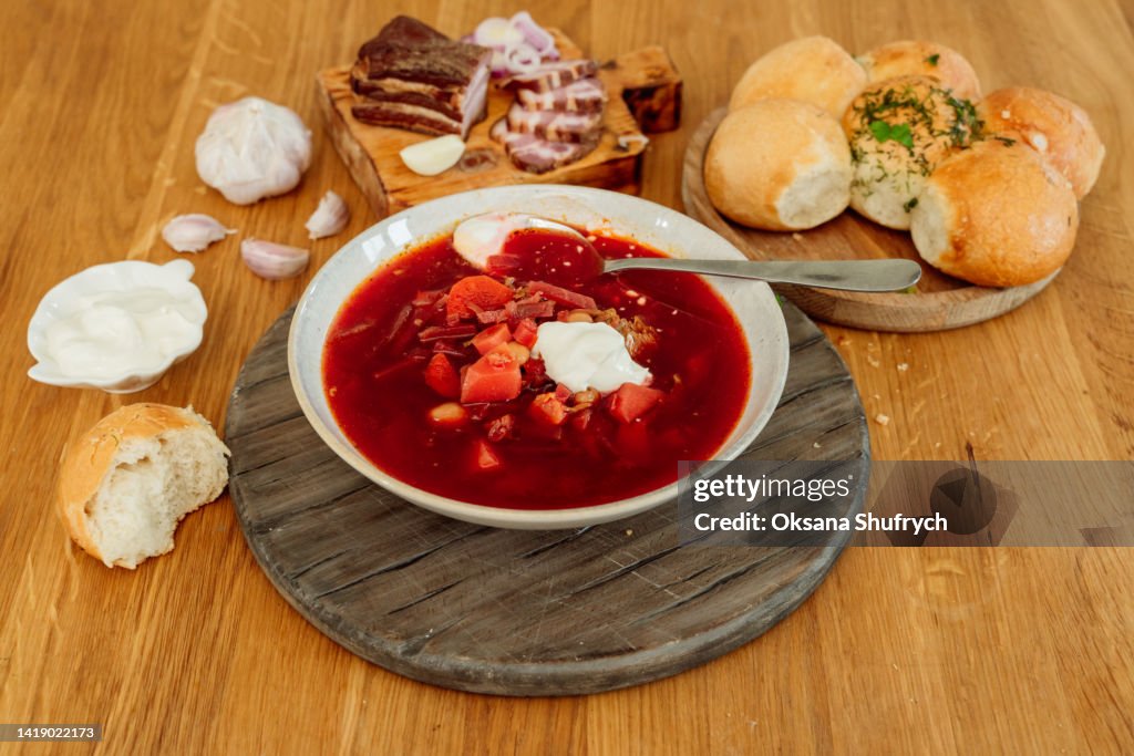 Borscht with cream sour and buns (pampushky) - traditional ukrainian beetroot soup