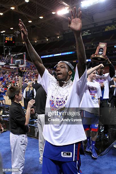 Tyshawn Taylor of the Kansas Jayhawks celebrates with the net around his net as he walks off of the court following their 80-67 win against the North...