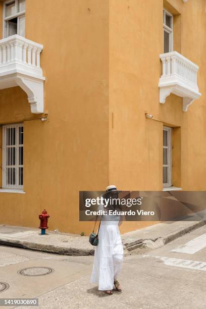 girl crossing the street in white dress - cartagena colombia stock pictures, royalty-free photos & images