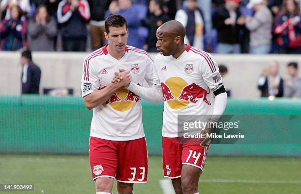 Kenny Cooper and Thierry Henry of the New York Red Bulls celebrate after defeating the Colorado Rapids at Red Bull Arena on March 25, 2012 in...