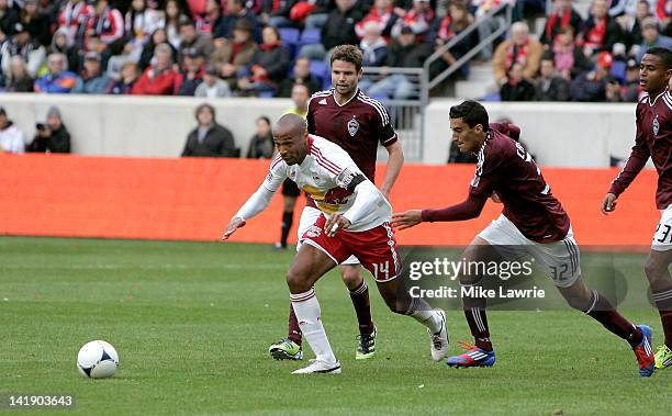 Thierry Henry of the New York Red Bulls dribbles between Drew Moor and Tony Cascio of the Colorado Rapids at Red Bull Arena on March 25, 2012 in...