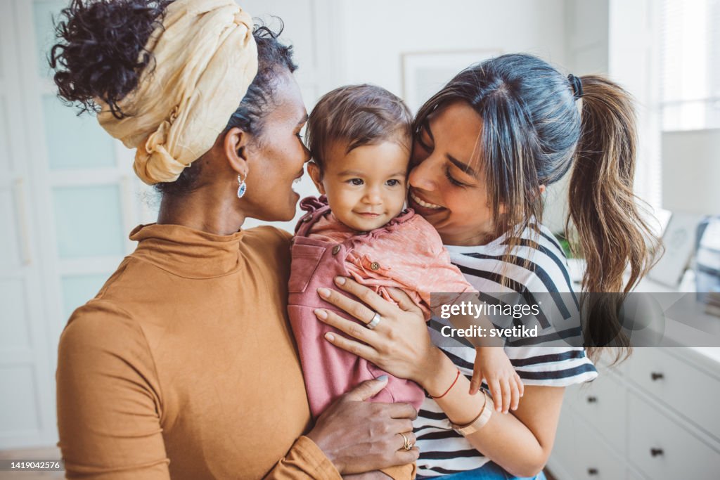 Gay couple with baby at home