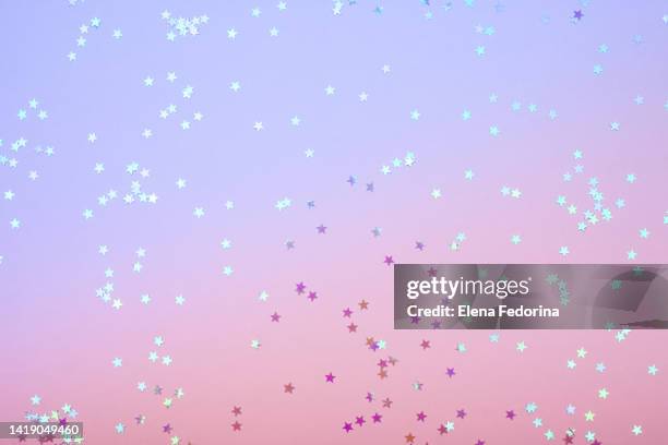 festive background with glitter stars. - pastel confetti stock pictures, royalty-free photos & images