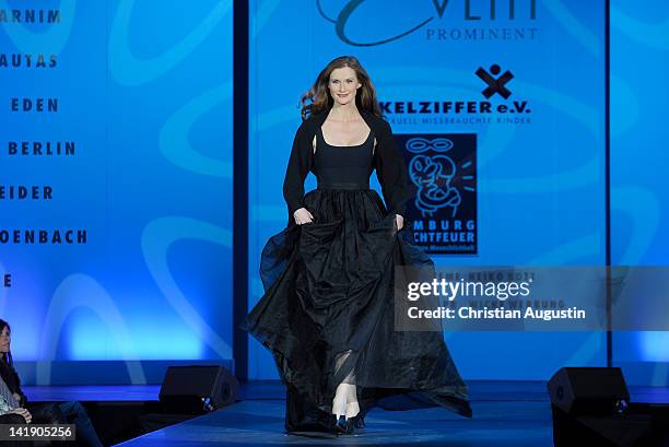 Karina Krawczyk shows designs on the catwalk during the charity event "Event Prominent" at the Hotel Grand Elysee on March 25, 2012 in Hamburg,...