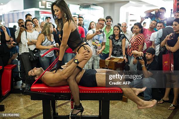 Models show the use of the special furniture for sex at "Erotika Fair" in Sao Paulo, Brazil on March 25, 2012. The annual fair of products and...