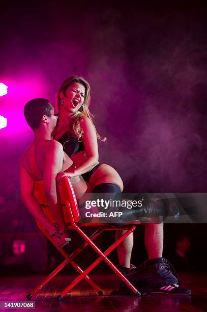 Dancer performs a strip dance with a spectator during a strip dance contest during the "Erotika Fair" in Sao Paulo, Brazil on March 25, 2012. The...