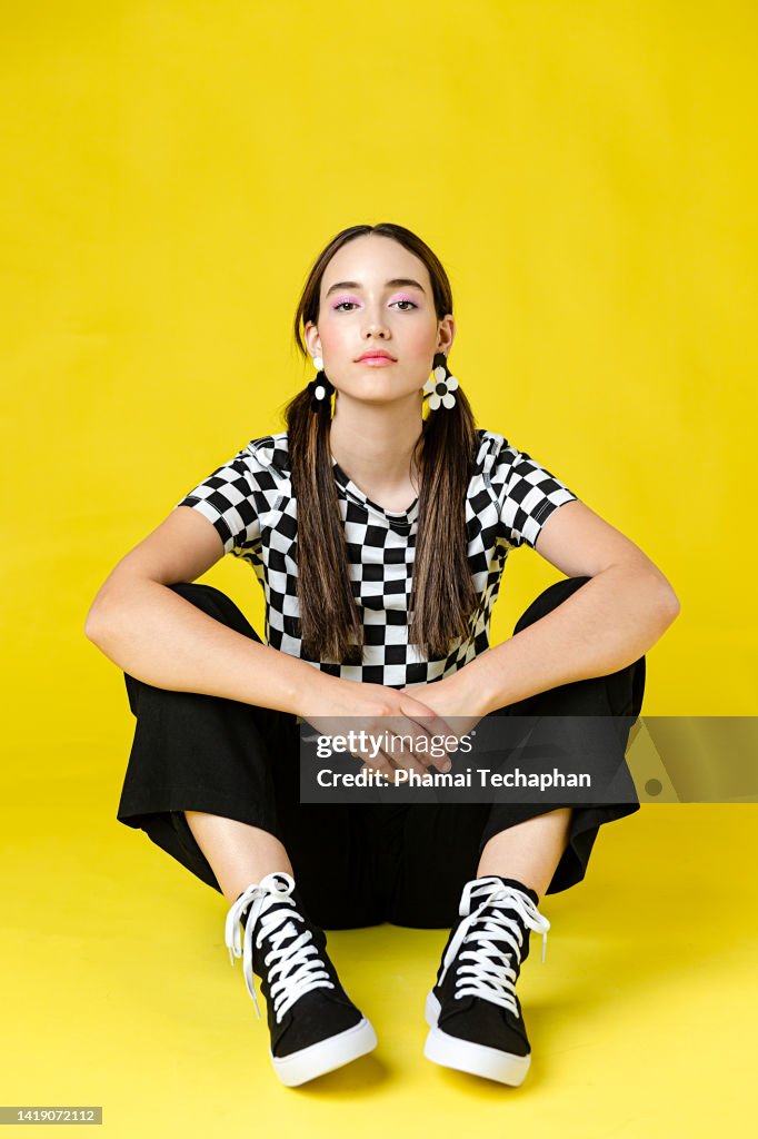 Stylish woman in front of plain background