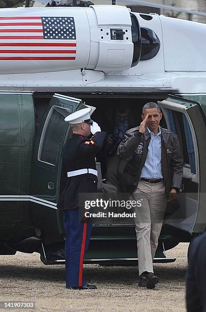 In this handout image provided by Yonhap News, U.S. President Barack Obama disembarks Marine One upon arrival at the Joint Security Area of the...