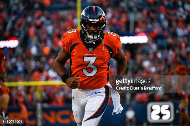 Quarterback Russell Wilson of the Denver Broncos runs onto the field before a preseason NFL game against the Minnesota Vikings at Empower Field at...