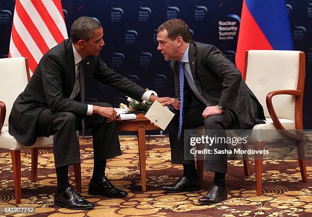 President Barack Obama and Russian President Dmitry Medvedev talk during the 2012 Seoul Nuclear Security Summit at the Hankuk University of Foreign...