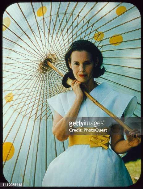 Portrait of American socialite, heiress, and fashion designer Gloria Vanderbilt as she poses with bamboo parasol, circa 1966.