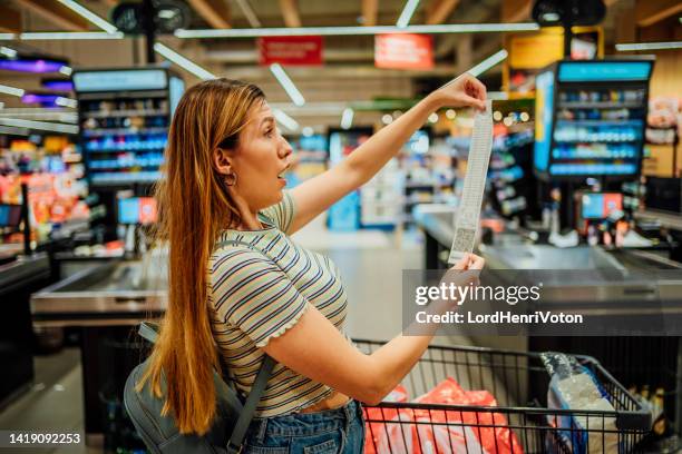 woman feeling shocked about rising grocery prices - shopping disappointment stock pictures, royalty-free photos & images